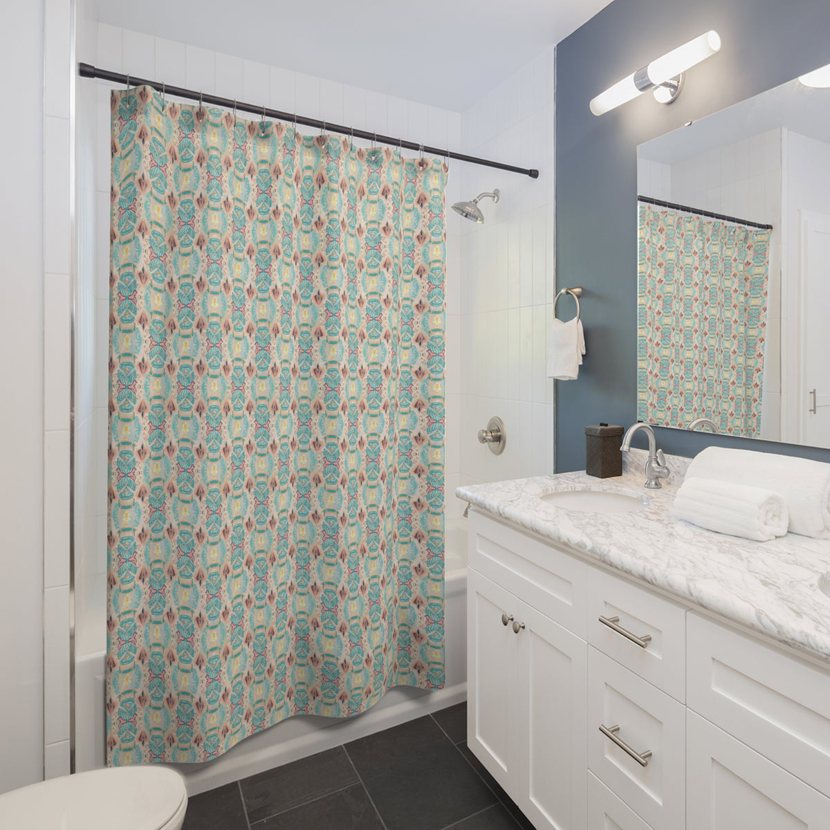 Bathroom with a patterned shower curtain, white vanity, and mirror.